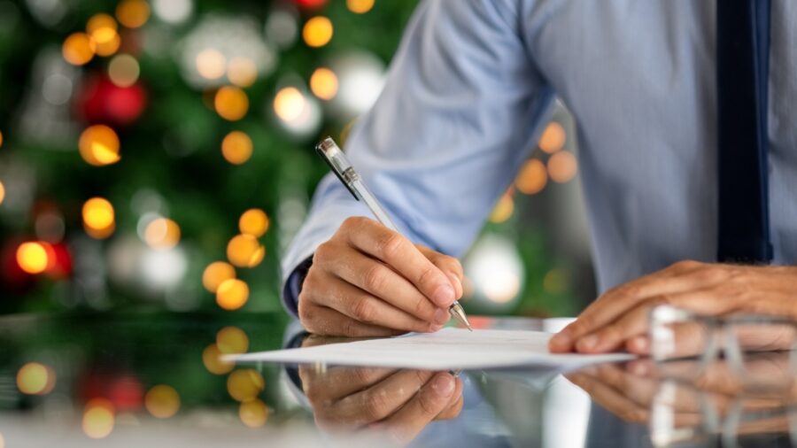 Holiday cards on a desk with festive decorations